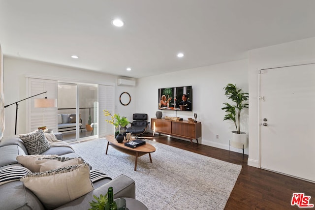 living room with an AC wall unit and dark wood-type flooring