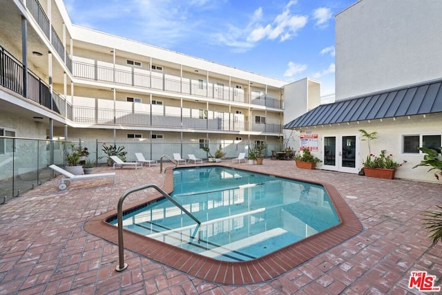 view of pool featuring a patio area and french doors