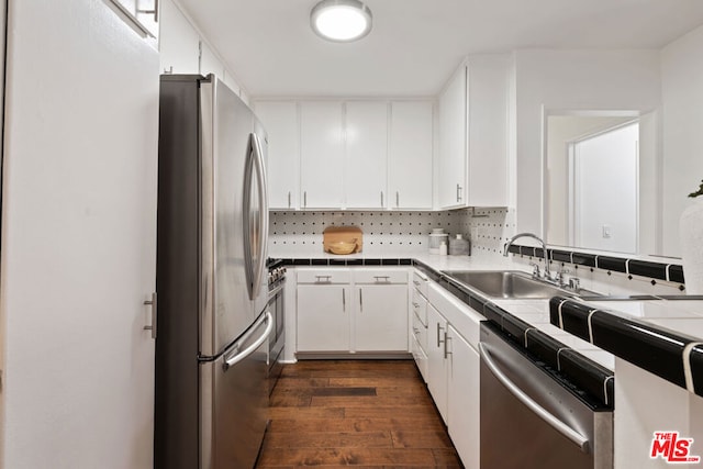 kitchen with dark hardwood / wood-style floors, white cabinetry, sink, tile counters, and stainless steel appliances