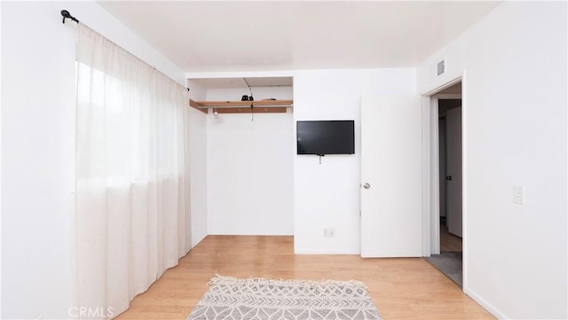 spare room with light hardwood / wood-style flooring