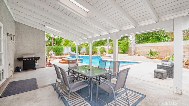 view of patio featuring grilling area and a swimming pool with hot tub