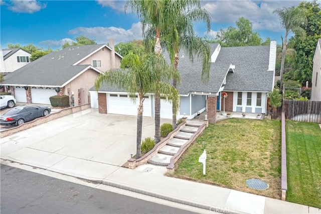 view of front of home with a garage and a front lawn