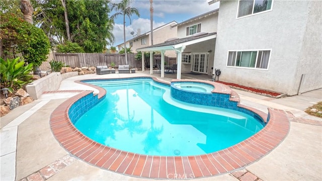 view of swimming pool featuring french doors, an in ground hot tub, outdoor lounge area, and a patio