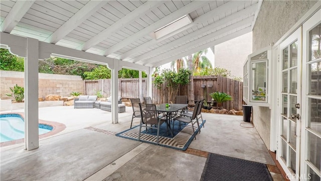 view of patio / terrace featuring a fenced in pool and an outdoor living space