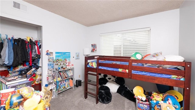 bedroom with a textured ceiling and carpet floors