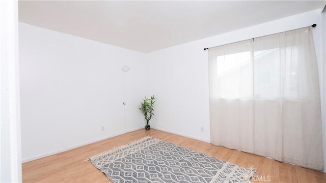 empty room with hardwood / wood-style floors