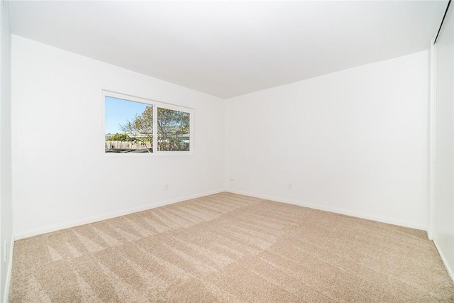 empty room featuring light carpet