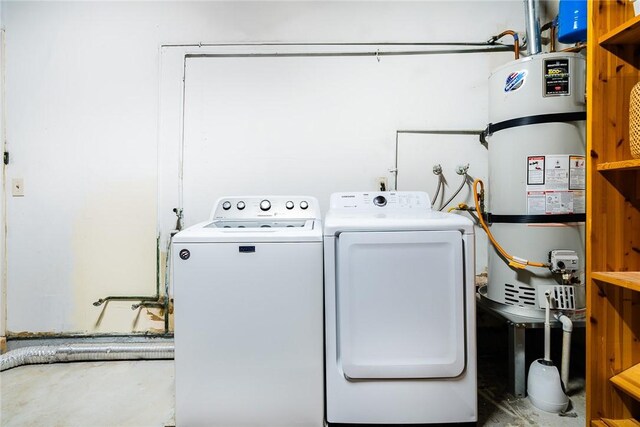 laundry area featuring strapped water heater and washing machine and clothes dryer