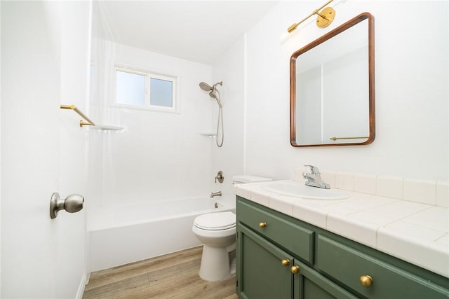 full bathroom with toilet, vanity, hardwood / wood-style floors, and shower / bath combination