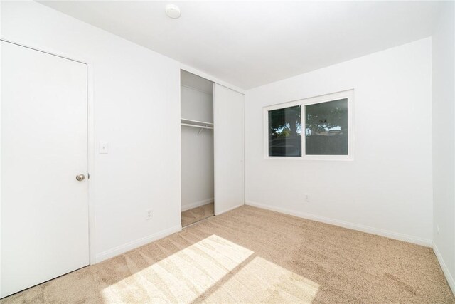 unfurnished bedroom featuring a closet and carpet