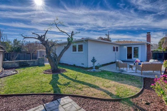 back of property with a patio area, an outdoor living space, and a lawn