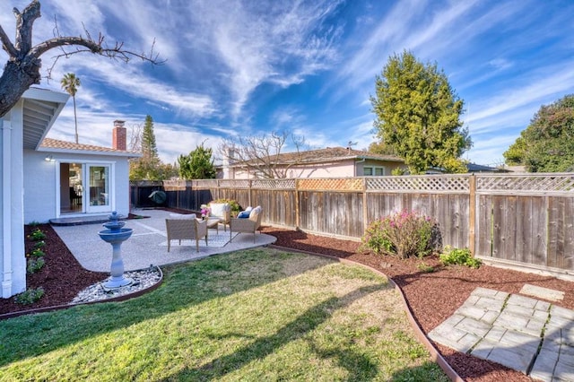 view of yard with an outdoor living space and a patio area