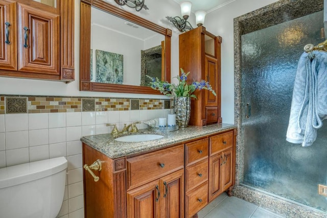 bathroom with tile patterned flooring, vanity, toilet, a shower with shower door, and crown molding