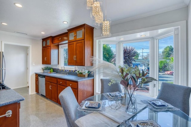 kitchen with pendant lighting, stainless steel appliances, an inviting chandelier, sink, and ornamental molding