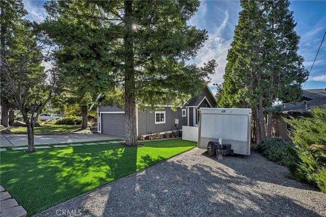 view of front of house featuring a garage and a front lawn