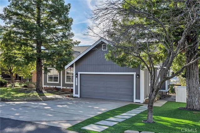 view of front of home with a front lawn and a garage