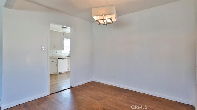 unfurnished room with hardwood / wood-style flooring