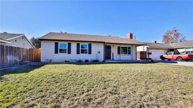 ranch-style house with a garage and a front lawn