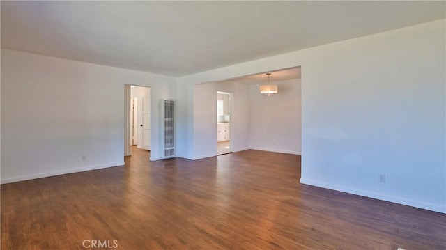 spare room featuring dark hardwood / wood-style flooring