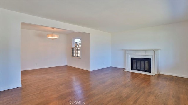 unfurnished living room with dark wood-type flooring