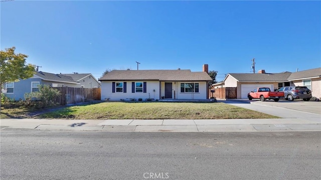 ranch-style home with a front lawn and a garage