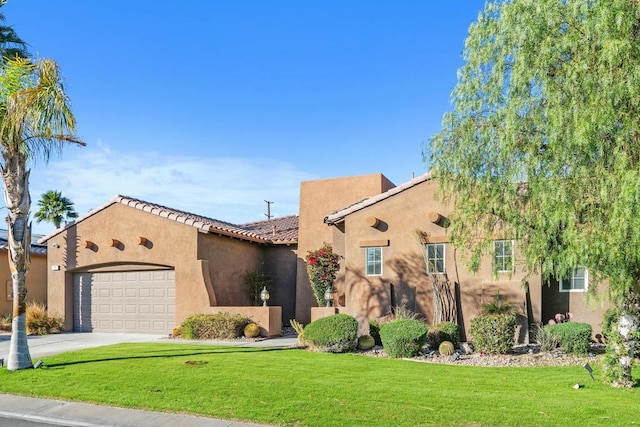 pueblo-style house with a front lawn and a garage