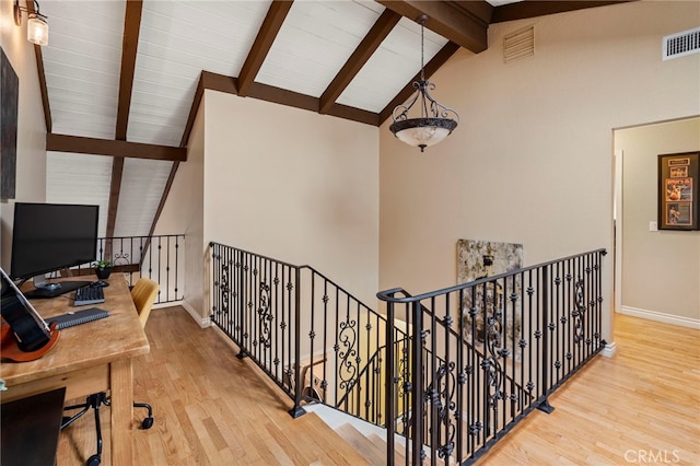 office area featuring hardwood / wood-style flooring and vaulted ceiling with beams