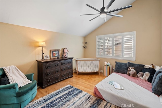 bedroom with lofted ceiling, ceiling fan, and light hardwood / wood-style flooring