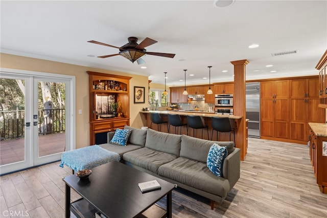 living room featuring ornamental molding, ceiling fan, french doors, and light wood-type flooring