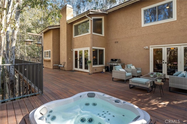 deck featuring french doors, an outdoor hangout area, and a grill