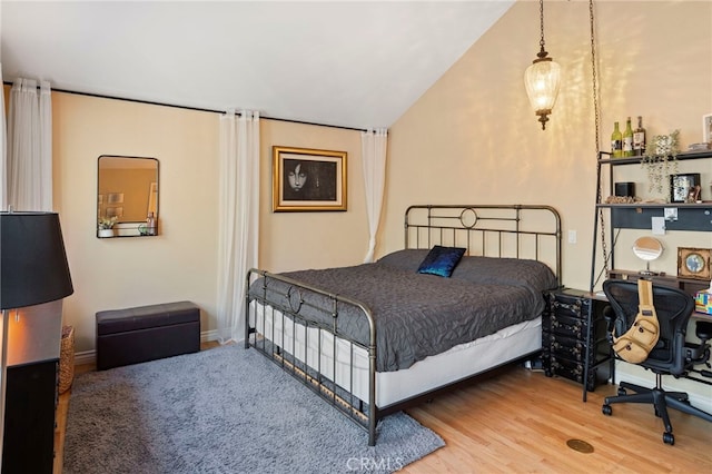 bedroom featuring lofted ceiling and wood-type flooring