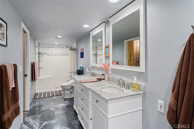 bathroom with toilet, a shower with shower curtain, and vanity