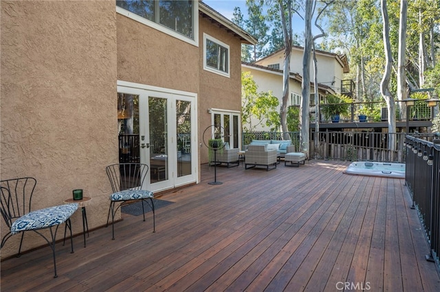 deck featuring french doors, an outdoor living space, and an outdoor hot tub