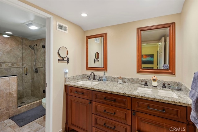 bathroom featuring toilet, an enclosed shower, tile patterned flooring, and vanity