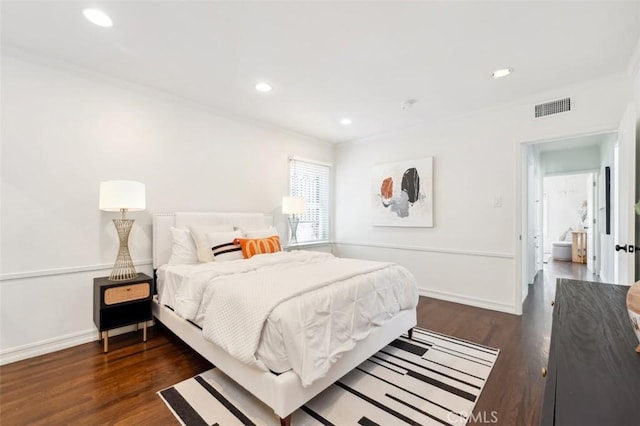 bedroom featuring ornamental molding and dark wood-type flooring