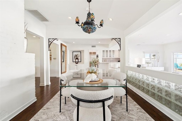 dining space with an inviting chandelier and hardwood / wood-style floors