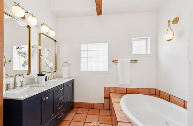 bathroom featuring vanity, tile patterned flooring, and a relaxing tiled tub