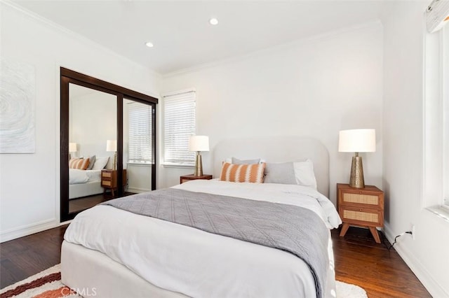 bedroom featuring a closet, crown molding, and dark hardwood / wood-style flooring