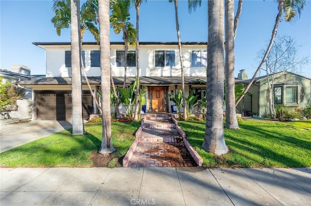 view of front of property with a front yard and a garage