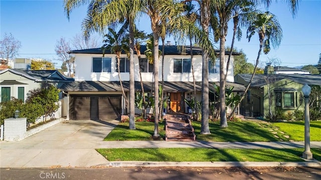 view of front of home featuring a front lawn and a garage