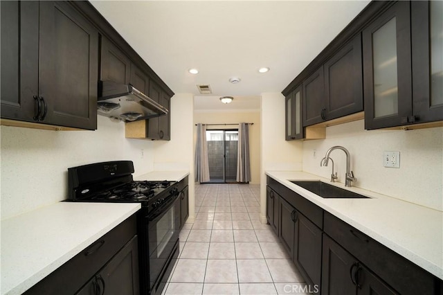 kitchen featuring black range with gas cooktop, dark brown cabinetry, light tile patterned floors, and sink