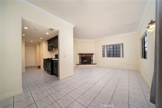 unfurnished living room featuring ornamental molding and light tile patterned floors