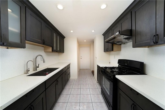 kitchen featuring sink, black range with gas stovetop, and light tile patterned floors