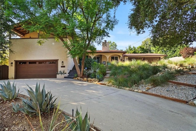 mediterranean / spanish home with a garage