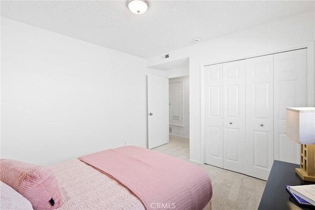 carpeted bedroom with a closet