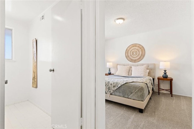 carpeted bedroom featuring a textured ceiling