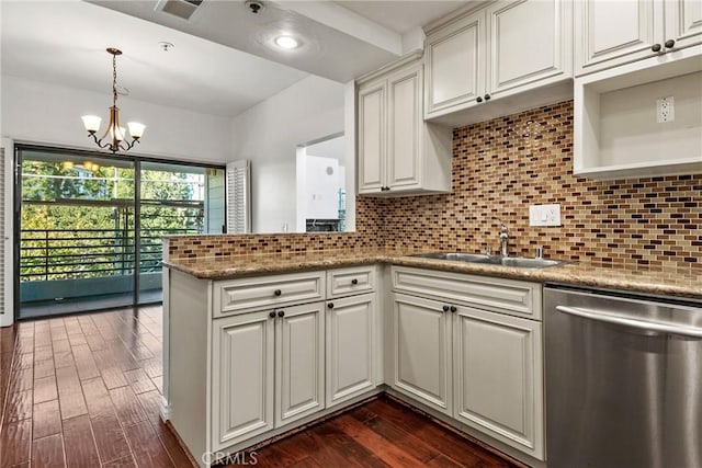 kitchen with a chandelier, kitchen peninsula, decorative backsplash, sink, and stainless steel dishwasher