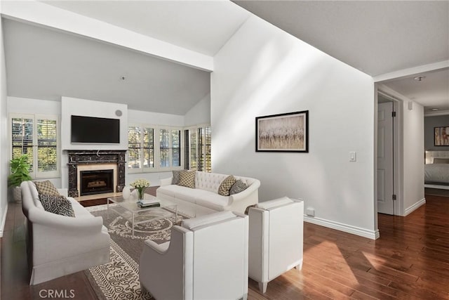 living room featuring a fireplace, hardwood / wood-style floors, a wealth of natural light, and beam ceiling