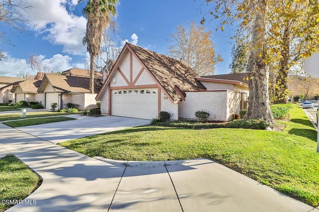 tudor home featuring a garage and a front lawn