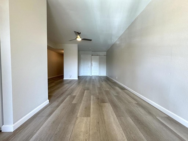 unfurnished living room featuring ceiling fan and light hardwood / wood-style floors